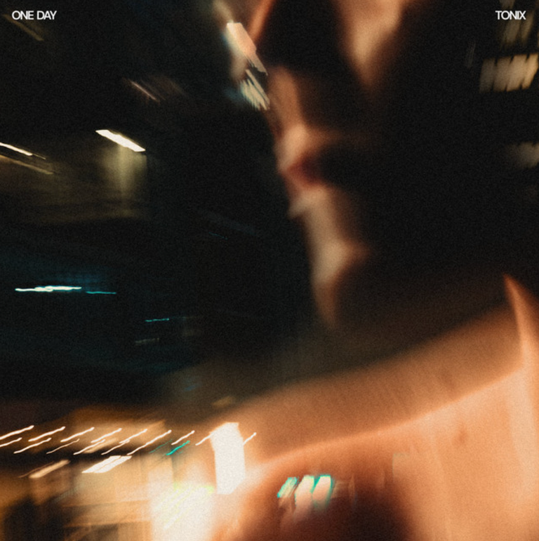 Single artwork for Tonix's track One Day featuring a motion-blurred, warm-toned night portrait with streaking city lights.